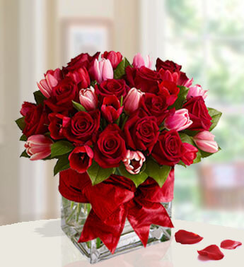 Arrangement of 20 Red Roses and 10 Red, 10 Pink Tulip with fillers in a cube vase. I love you